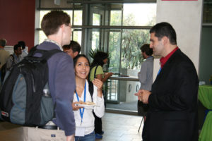 Attendees standing near posters on easels and mingling at the CNS Research Review, July 16-17, 2008 Poster Session in CSE Foyer