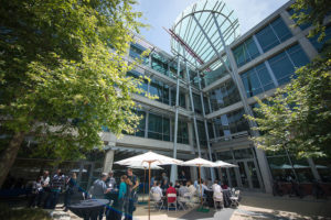 Attendees sitting at tables eating lunch at CNS Research Review, October 22, 2014, at CSE Courtyard, UCSD
