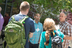 Attendees sitting at tables eating lunch at CNS Research Review, October 22, 2014, at CSE Courtyard, UCSD