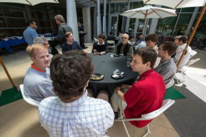 Attendees sitting at tables eating lunch at CNS Research Review, October 22, 2014, at CSE Courtyard, UCSD