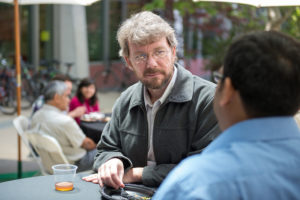 Attendees sitting at tables eating lunch at CNS Research Review, October 22, 2014, at CSE Courtyard, UCSD