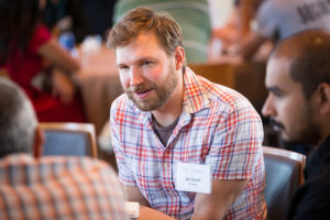 Attendees sitting at tables eating lunch at CNS Research Review, October 13, 2016, at the Great Hall, UCSD